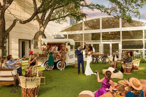 a bride and groom getting married in front of a food truck at Renaissance Austin Hotel in Austin