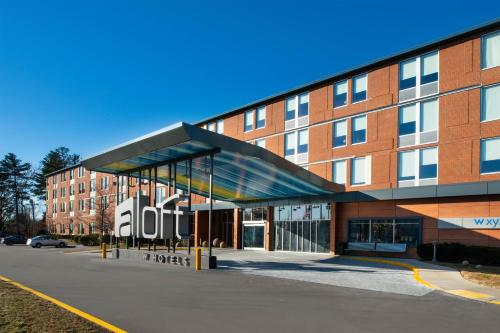 a building with a large sign in front of it at Aloft Lexington in Lexington