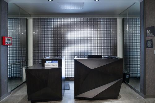 an office with two desks and a large wall of glass at Aloft Charlotte Airport in Charlotte