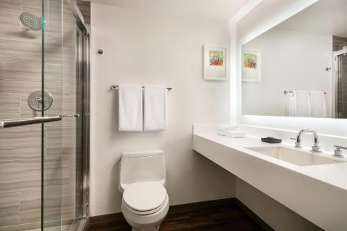 a bathroom with a toilet and a sink and a shower at Aloft Mountain View in Mountain View
