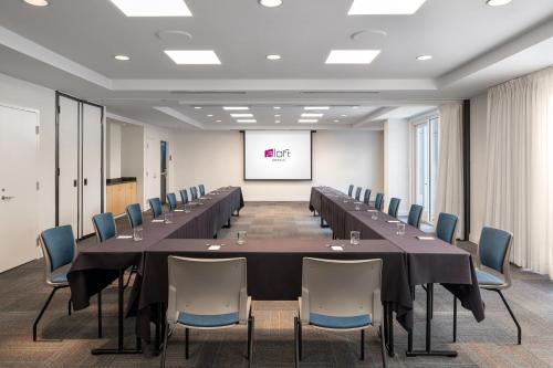 a large conference room with a long table and chairs at Aloft Mountain View in Mountain View