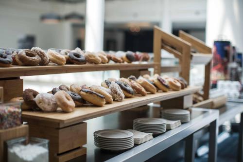 a bunch of donuts on display in a bakery at Renaissance Baltimore Harborplace Hotel in Baltimore