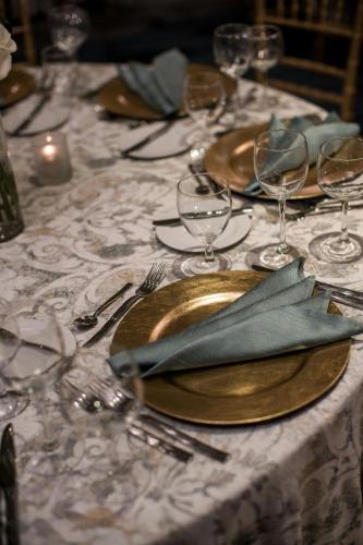 a table topped with gold plates and wine glasses at Renaissance Baltimore Harborplace Hotel in Baltimore