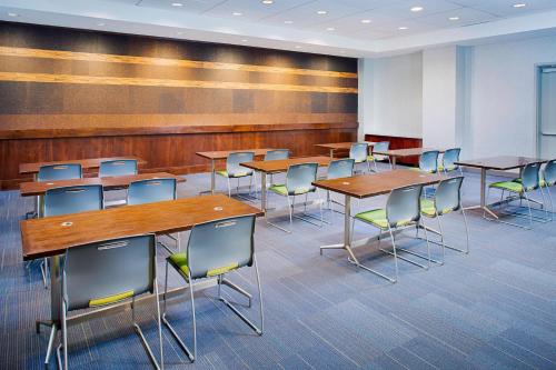 a classroom with tables and chairs in a room at Aloft Charlotte City Center in Charlotte