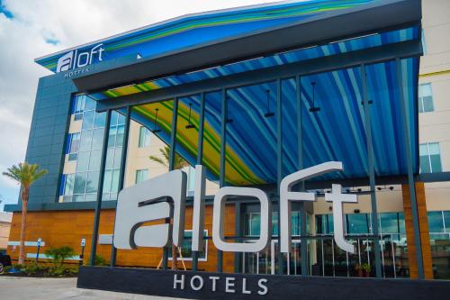 a hotel sign in front of a building at Aloft Corpus Christi in Corpus Christi