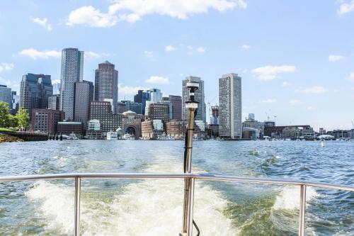 a boat in the water in front of a city at Renaissance Boston Seaport District in Boston