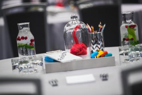 a table with a glass jar with red yarn in it at Renaissance Boston Seaport District in Boston