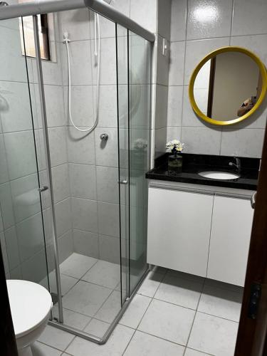 a bathroom with a shower and a sink and a mirror at Tambaú Beach apartment in João Pessoa
