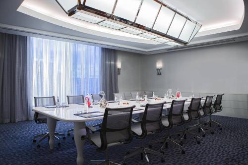 a large conference room with a long table and chairs at Renaissance Boston Seaport District in Boston