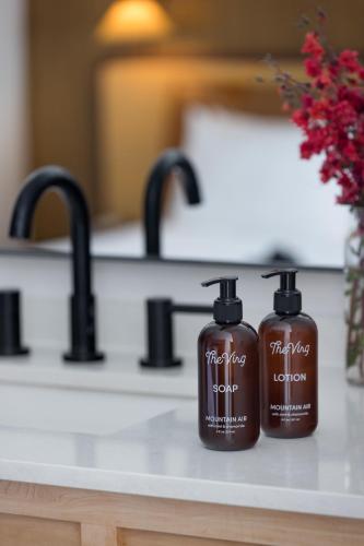 two bottles of soap on a counter in a bathroom at The Virginian Lodge in Jackson