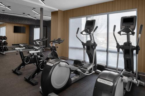a gym with cardio machines and a large window at AC Hotel Park City in Park City