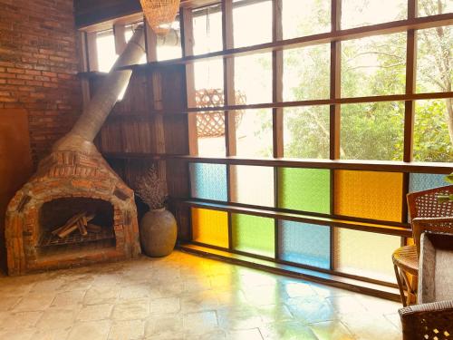 a room with a large window with a fireplace at Monsamkien Farmstay in Phayao