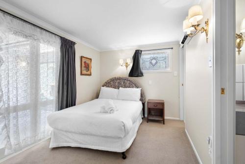 a bedroom with a white bed and a window at Stunning Lake Views & Hospital Location in Hamilton