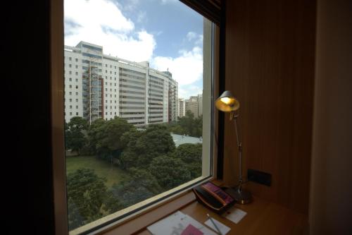 a window with a view of a large building at Aloft Bengaluru Whitefield in Bengaluru