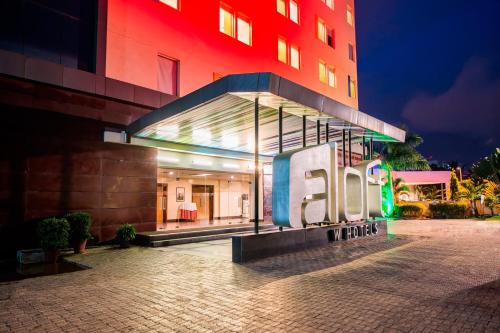 a building with a sign in front of it at night at Aloft Bengaluru Whitefield in Bengaluru