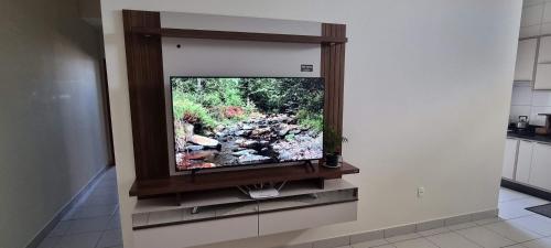 a flat screen tv on a wall in a kitchen at Apartamento Barra Velha Praia do Tabuleiro in Barra Velha