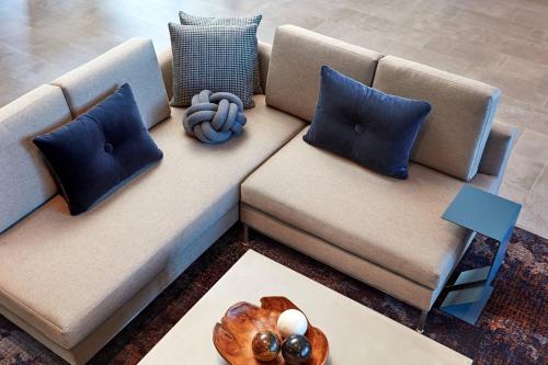 a couch with pillows and a bowl of balls on it at AC Hotel by Marriott San Jose Santa Clara in Santa Clara