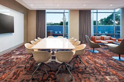 a conference room with a white table and chairs at AC Hotel by Marriott San Jose Santa Clara in Santa Clara