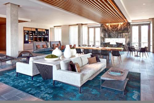 a living room with a couch and a table at AC Hotel by Marriott Sunnyvale Cupertino in Sunnyvale