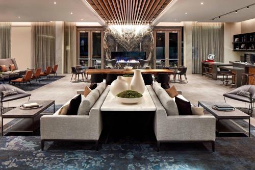 a living room with a couch and a table at AC Hotel by Marriott Sunnyvale Cupertino in Sunnyvale
