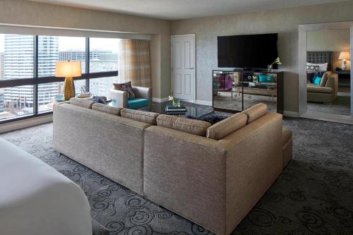 a living room with a couch and a television at Renaissance Nashville Hotel in Nashville