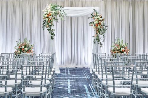 a row of chairs in a wedding aisle with flowers at Renaissance Nashville Hotel in Nashville