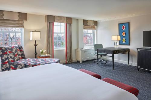 a hotel room with a bed and a desk at The Alexandrian Old Town Alexandria, Autograph Collection in Alexandria
