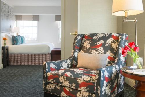 a room with a chair and a bedroom with a bed at The Alexandrian Old Town Alexandria, Autograph Collection in Alexandria
