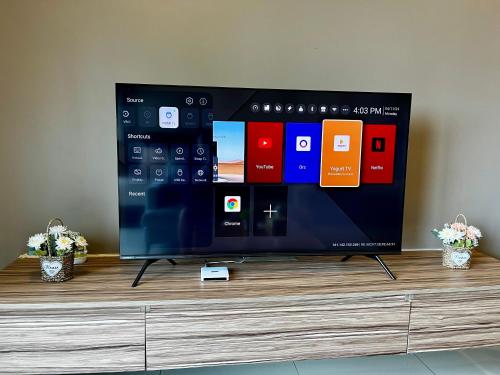 a flat screen tv sitting on top of a dresser at 1-5 Pax Comfy Trefoil Studio-Walk to Setia City Mall & Setia City Convention Centre in Shah Alam
