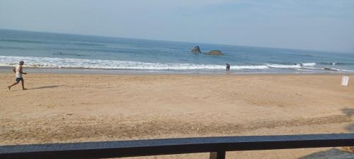 a couple of people walking on the beach at Nana's Nook in Agonda