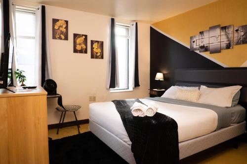 a hotel room with a bed and a television at Stay Pittsburgh in Pittsburgh