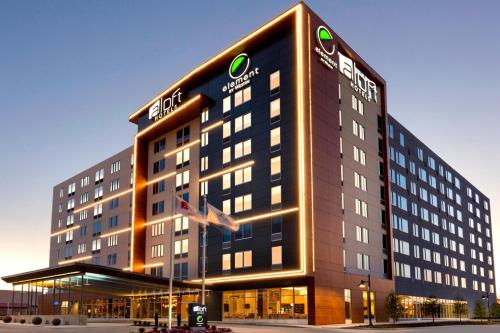 a large building with a sign in front of it at Aloft Dallas Love Field in Dallas