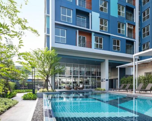 an image of an apartment building with a swimming pool at A family room at Lumpini Ville Sukhumvit 101-1 by Pikul in Bangkok