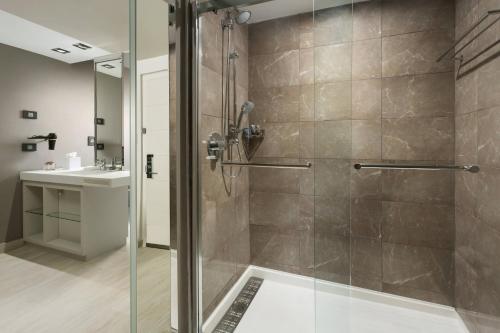 a bathroom with a shower and a sink at AC Hotel by Marriott San Juan Condado in San Juan