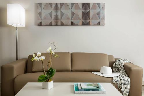 a living room with a couch and a table at AC Hotel by Marriott San Juan Condado in San Juan