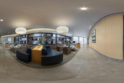 a library with couches and chairs in a building at AC Hotel by Marriott San Juan Condado in San Juan