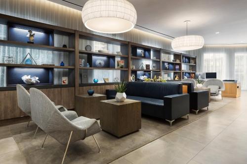 a living room with a couch and chairs and shelves at AC Hotel by Marriott San Juan Condado in San Juan
