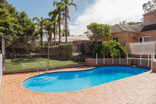 a swimming pool in the backyard of a house at Sunset Poolside - Stay 3, Pay 2 - Spring Specials! in Mollymook