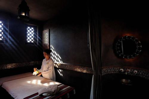 a boy standing next to a bed in a room at Villa Maroc Resort in Pran Buri