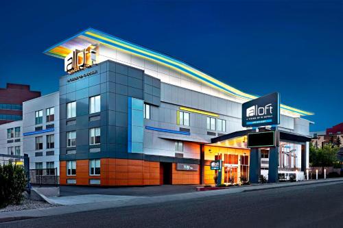 a hotel building with a sign on top of it at Aloft Hotel Calgary University in Calgary