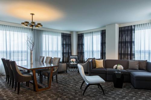 a living room with a couch and a table at Renaissance Chicago O'Hare Suites Hotel in Rosemont