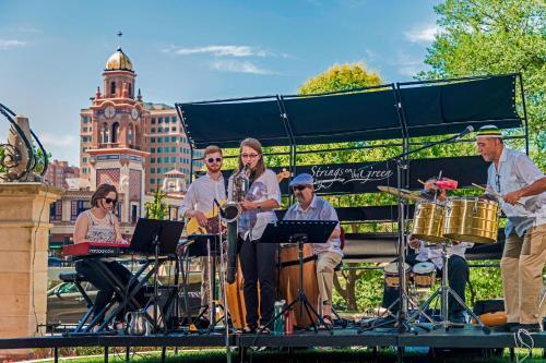 a group of people playing music on a stage at The Raphael Hotel, Autograph Collection in Kansas City