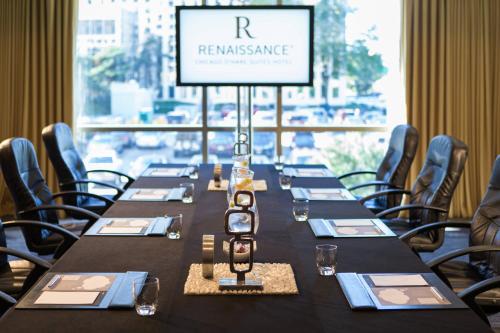 a long table in a room with a sign that reads resonance at Renaissance Chicago O'Hare Suites Hotel in Rosemont