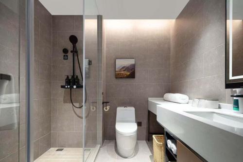 a bathroom with a shower and a toilet and a sink at Atour X Hotel Ningbo Zhenhaizhuang Avenue in Ningbo