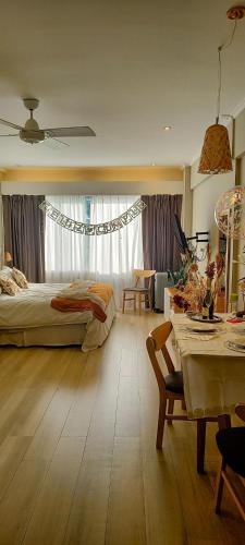 a bedroom with a bed and a table and a dining room at Patagonia D.A.T in San Carlos de Bariloche