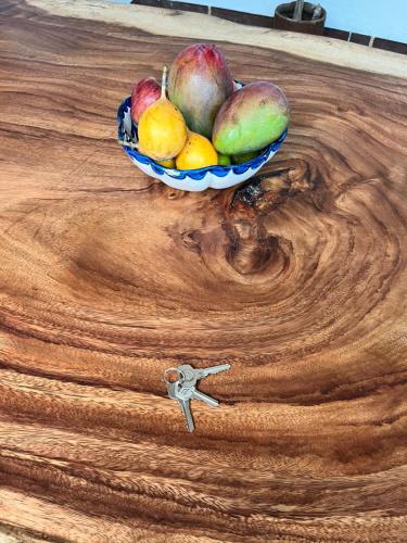 a bowl of fruit sitting on top of a wooden table at Patio Chic in Jericó
