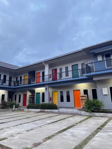 a row of buildings with colorful doors and windows at Roomstay Homestay Permai Inn Pekan in Pekan