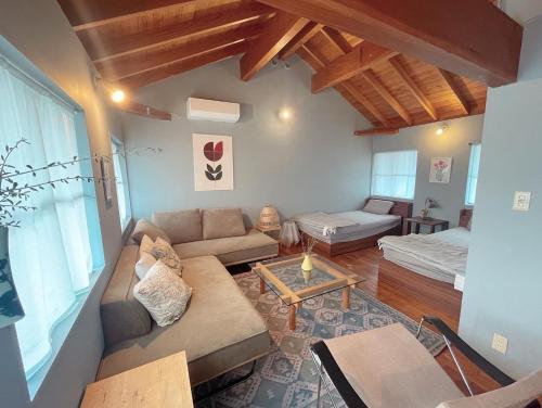 a living room with a couch and a table at AGASA residence in Fujieda