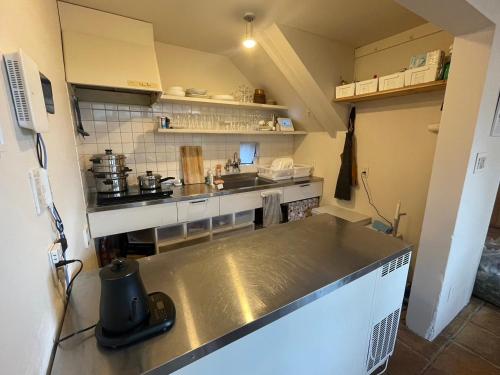 a kitchen with a stainless steel counter top at AGASA residence in Fujieda