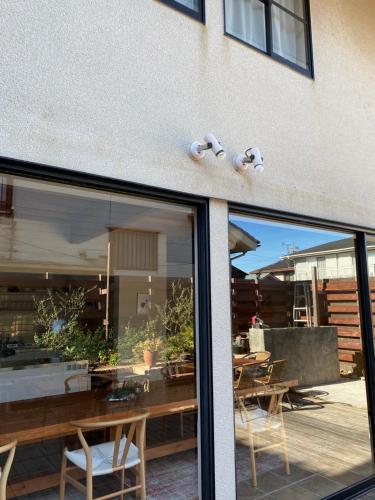 a window of a restaurant with a table and chairs at AGASA residence in Fujieda